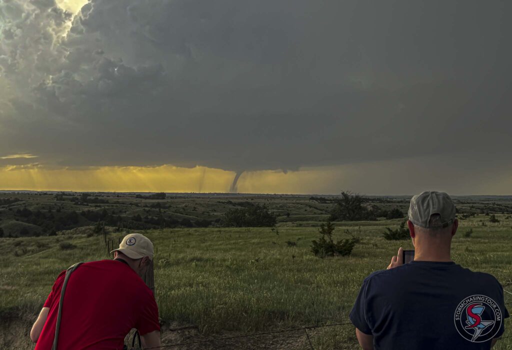 Tour guests photograph and video a tornado in Nebraska.